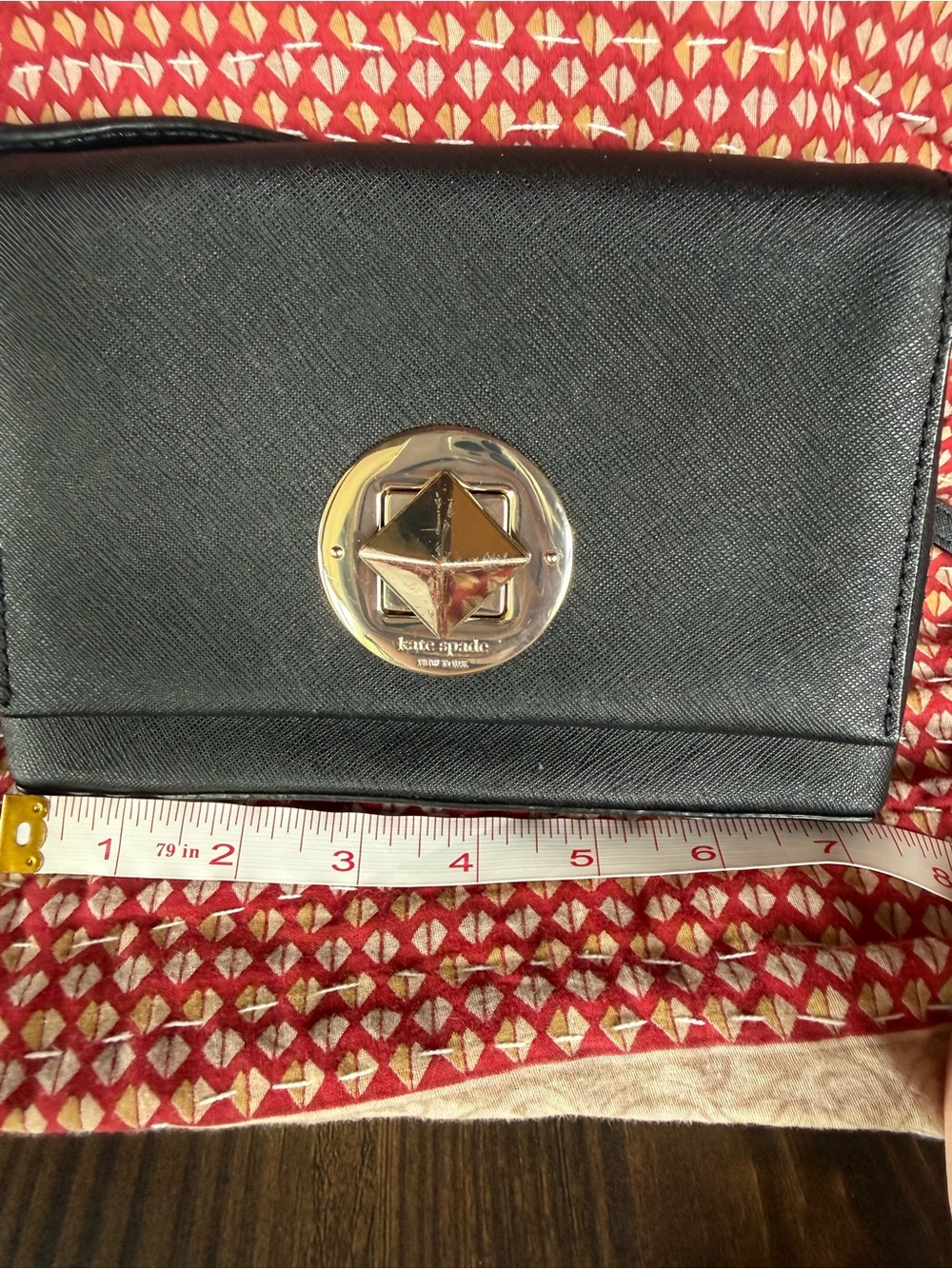 kate spade black leather crossbody with gold medallion